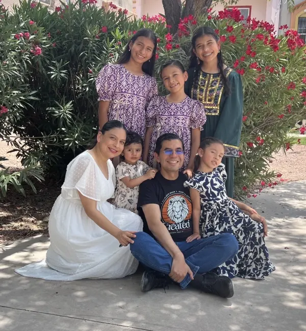 Deacon Alejandro DeLeigh with his wife and children